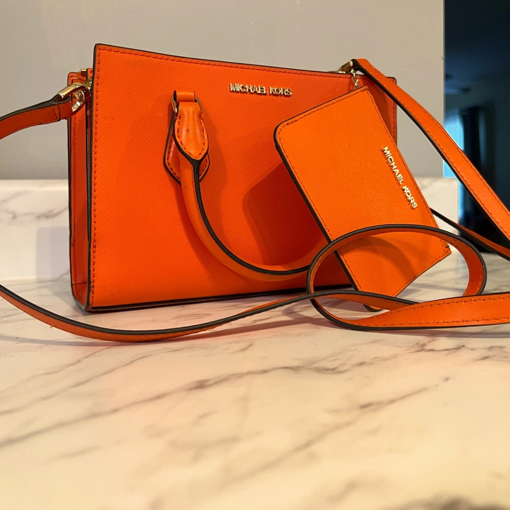 Michael Kors orange crossbody bag with matching wallet